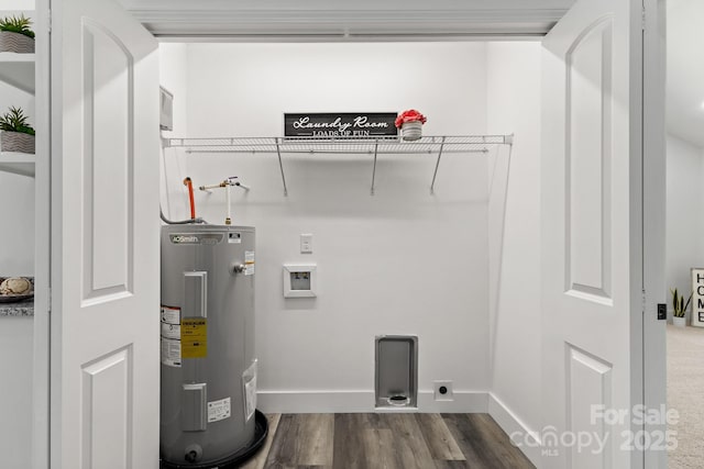 clothes washing area featuring water heater, electric dryer hookup, washer hookup, and dark hardwood / wood-style flooring