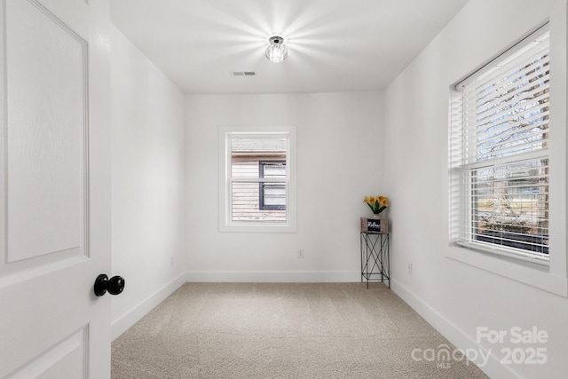 carpeted spare room with plenty of natural light