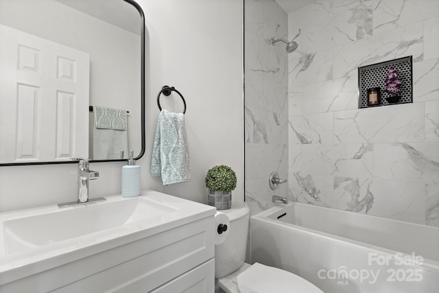 full bathroom featuring vanity, toilet, and tiled shower / bath combo