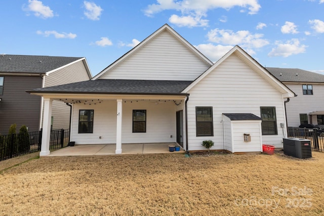 back of house featuring central AC, a yard, and a patio