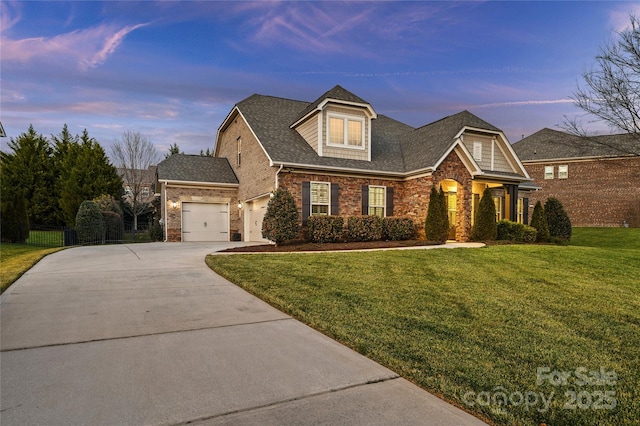 view of front of home featuring a garage and a lawn