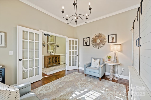 living area featuring french doors, dark hardwood / wood-style floors, a chandelier, and crown molding