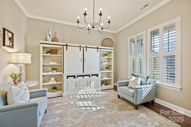 sitting room featuring hardwood / wood-style flooring, a notable chandelier, ornamental molding, and a wealth of natural light