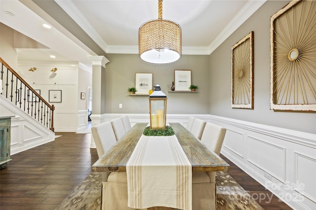 unfurnished dining area featuring ornamental molding, dark hardwood / wood-style floors, and ornate columns