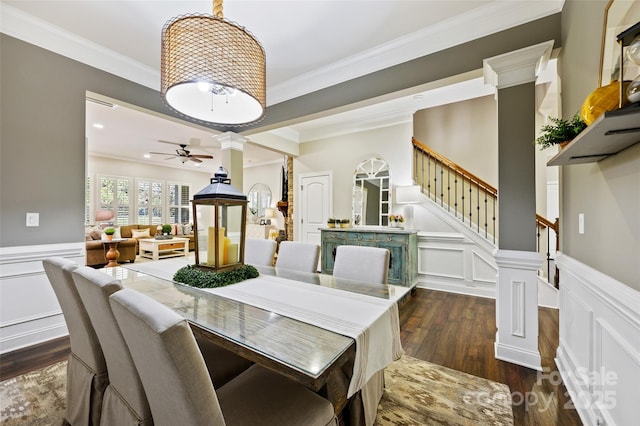 dining area featuring decorative columns, crown molding, ceiling fan, and dark hardwood / wood-style flooring