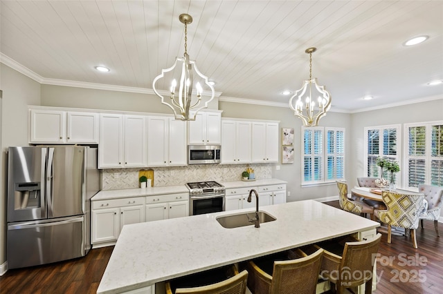 kitchen featuring appliances with stainless steel finishes, sink, a chandelier, and decorative light fixtures