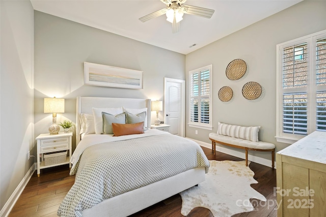 bedroom with dark hardwood / wood-style flooring and ceiling fan