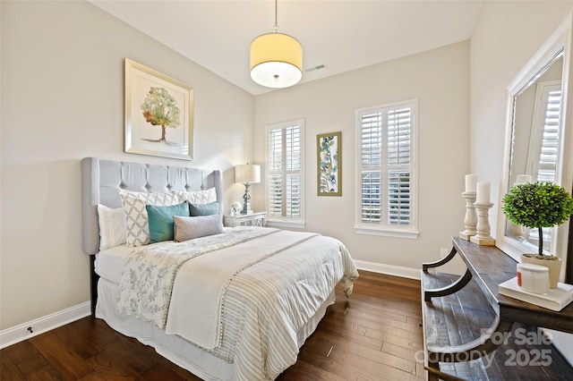 bedroom with dark hardwood / wood-style flooring