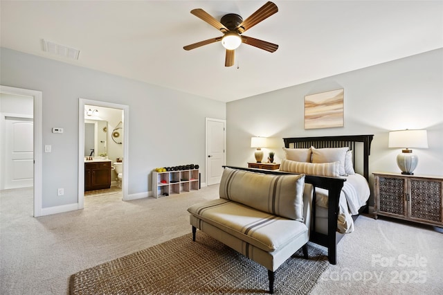 carpeted bedroom with ceiling fan and ensuite bath