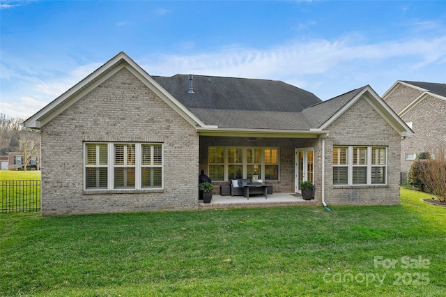 rear view of house with a yard and a patio area