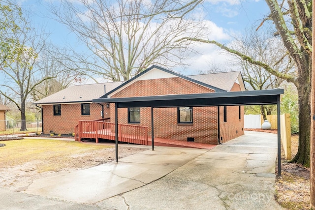 view of front facade featuring a wooden deck and a carport