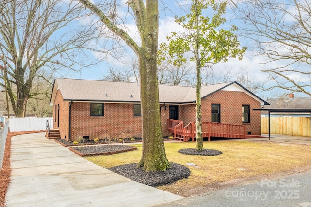 ranch-style house with a wooden deck and a front lawn