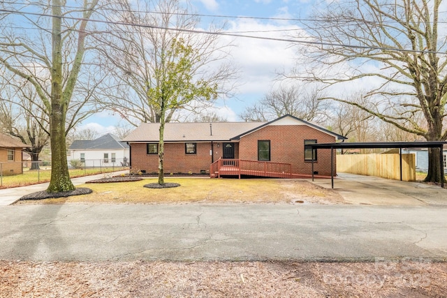 ranch-style home featuring a carport and a deck