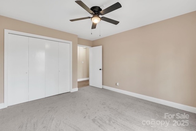 unfurnished bedroom with light carpet, ceiling fan, and a closet