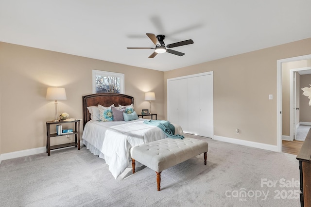 bedroom with light carpet, ceiling fan, and a closet