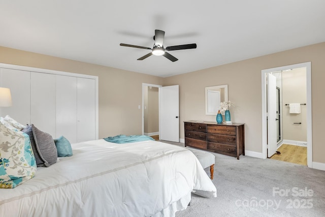 carpeted bedroom with ensuite bath, a closet, and ceiling fan