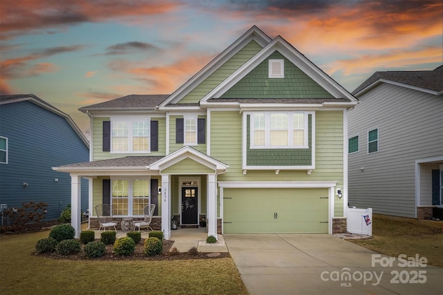 craftsman house with a garage and covered porch