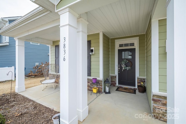 view of exterior entry with a porch