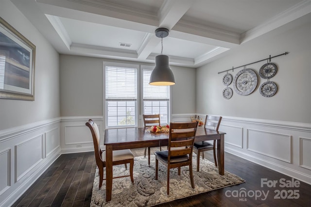 dining space with beamed ceiling, coffered ceiling, dark hardwood / wood-style floors, and ornamental molding