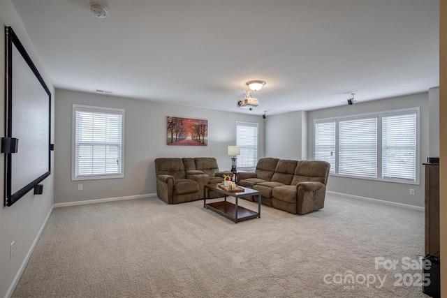 living room featuring a healthy amount of sunlight and light carpet