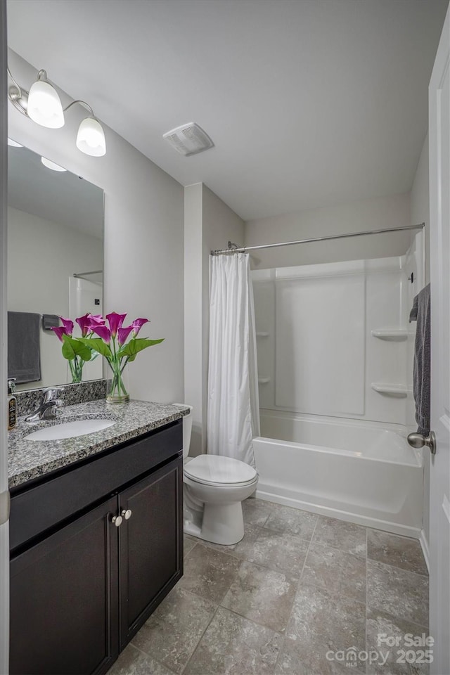 full bathroom featuring vanity, shower / tub combo, and toilet