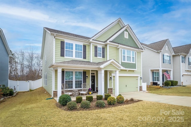 view of front of house with a porch, a garage, and a front yard