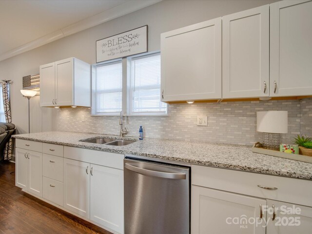 kitchen with tasteful backsplash, white cabinetry, dishwasher, sink, and light stone counters