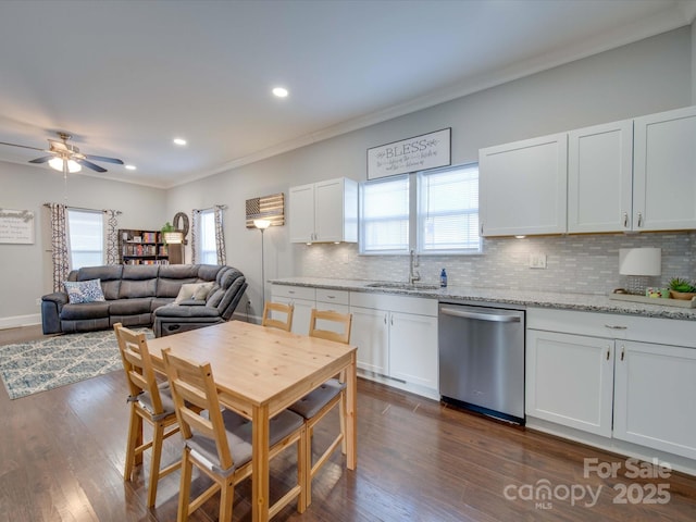 kitchen featuring light stone countertops, stainless steel dishwasher, dark hardwood / wood-style floors, and white cabinets