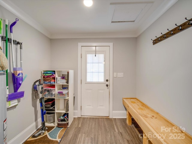 doorway to outside with wood-type flooring and ornamental molding