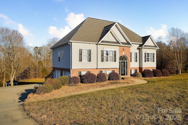 view of front of property with a garage and a front yard