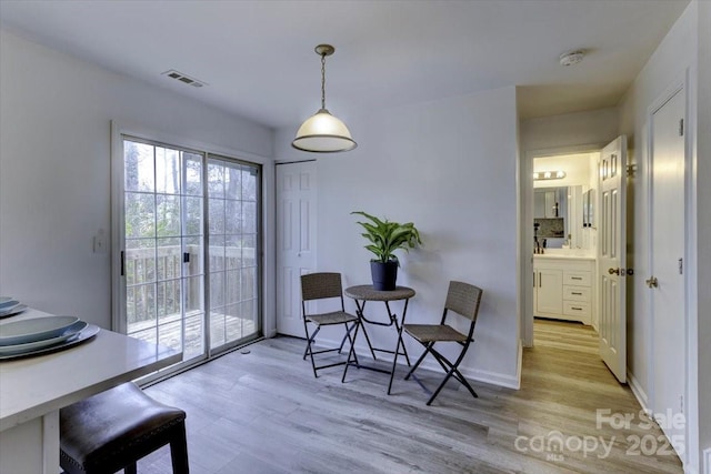 dining area with light hardwood / wood-style floors