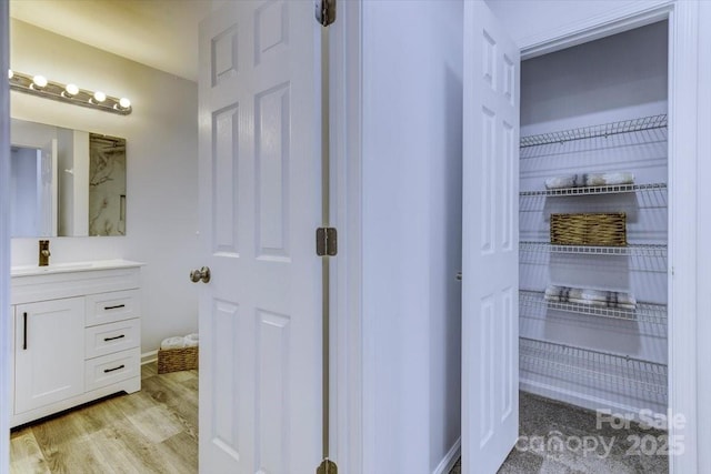 bathroom featuring vanity and hardwood / wood-style floors