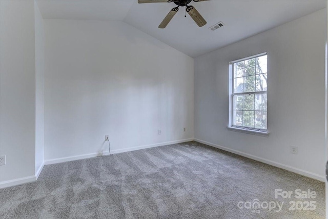 spare room with vaulted ceiling, carpet, and ceiling fan