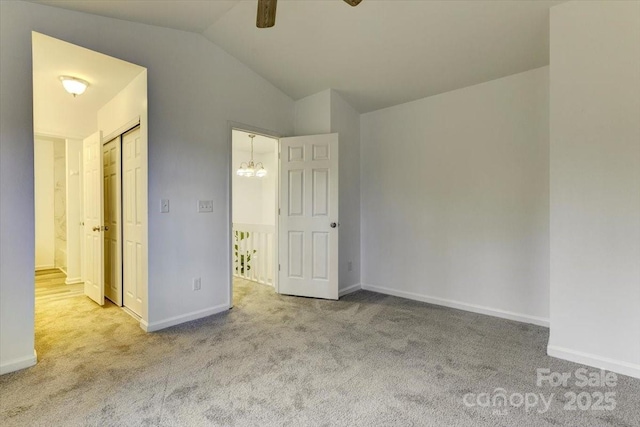 unfurnished bedroom with lofted ceiling, light carpet, and ceiling fan