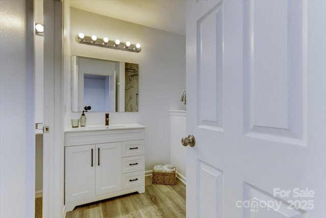 bathroom with vanity and hardwood / wood-style floors