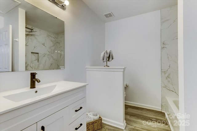 bathroom featuring vanity, wood-type flooring, and shower / washtub combination