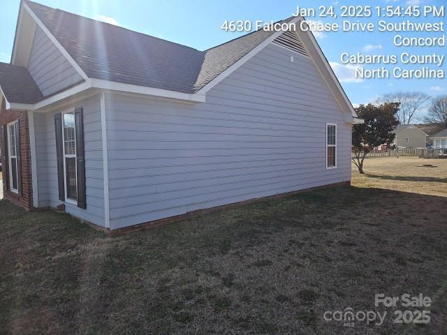 view of property exterior with a lawn