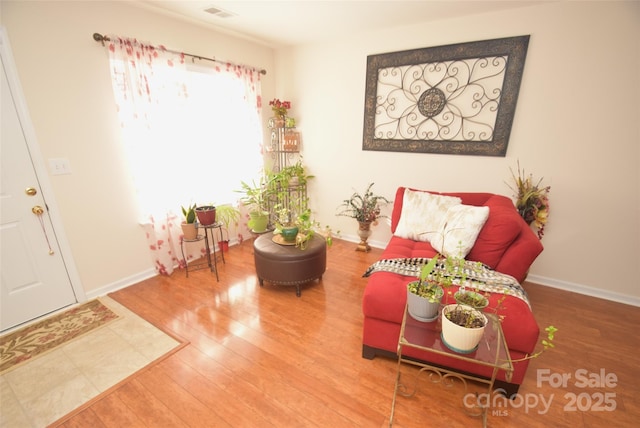 living area with hardwood / wood-style floors