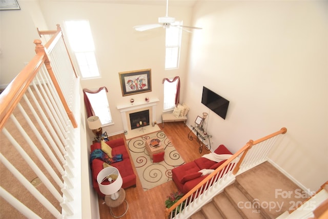 living room with wood-type flooring and ceiling fan