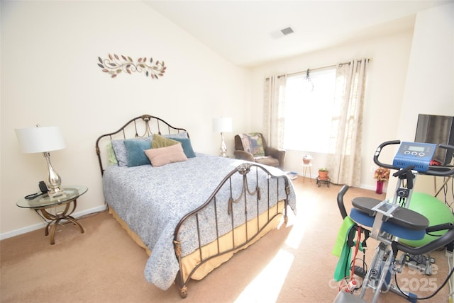 bedroom featuring lofted ceiling and light carpet