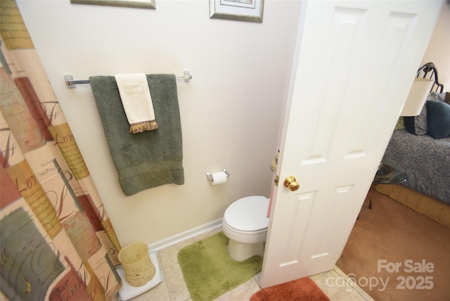 bathroom featuring tile patterned floors and toilet