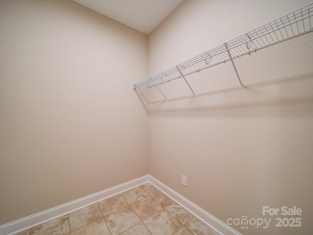 spacious closet featuring tile patterned flooring