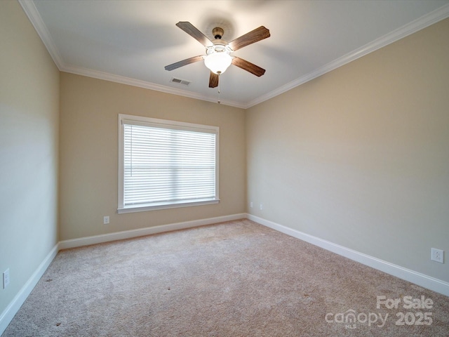 spare room featuring crown molding, light colored carpet, and ceiling fan