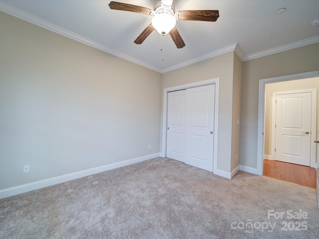 unfurnished bedroom with crown molding, a closet, ceiling fan, and light carpet