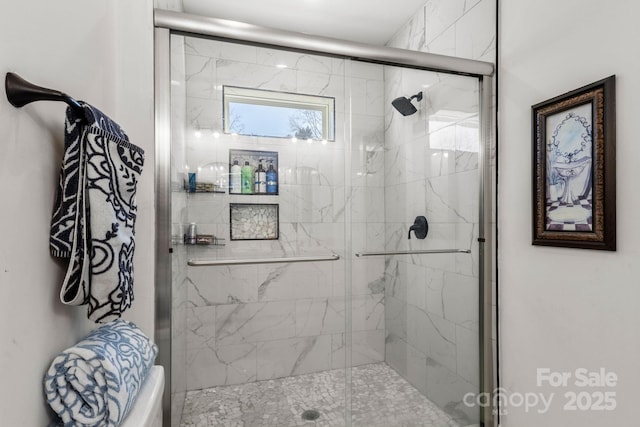 bathroom featuring a shower with shower door