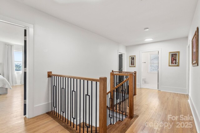 hallway with light hardwood / wood-style floors