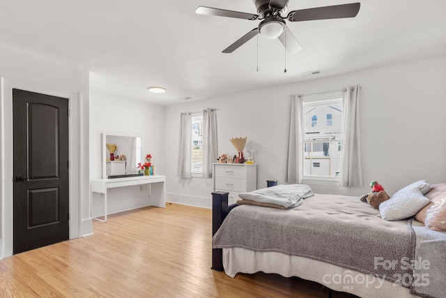 bedroom with light hardwood / wood-style floors and ceiling fan