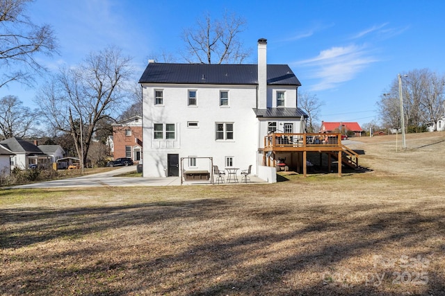 back of house with a yard, a deck, and a patio