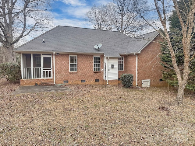 rear view of property with a sunroom and a patio area