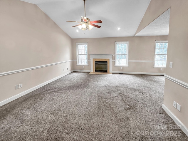 unfurnished living room with ceiling fan, lofted ceiling, carpet, and a wealth of natural light